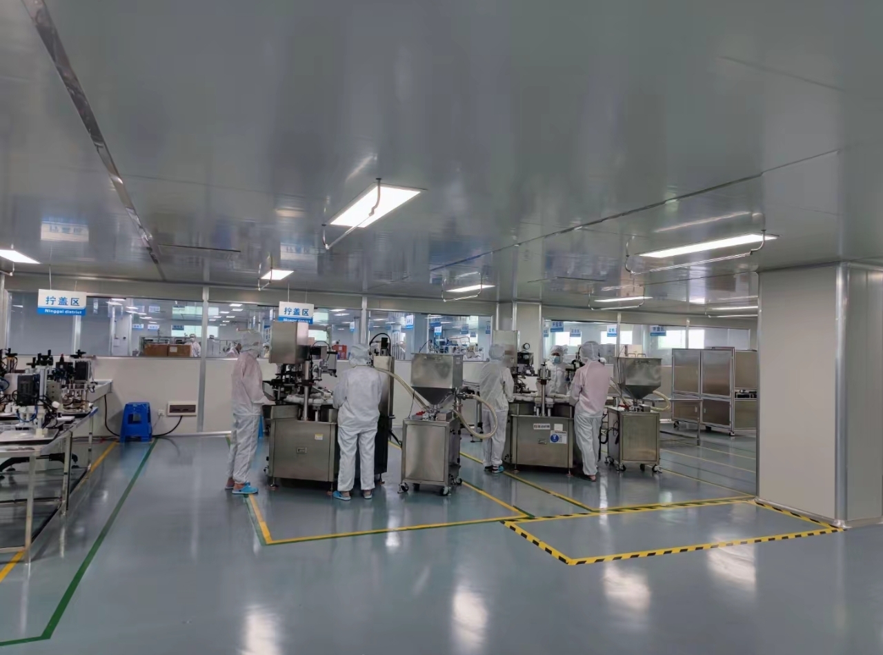 Personnel working in a packaging area, as shown in the supplied photograph.